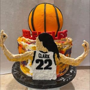 A cake with caitlin clark and a basketball on top