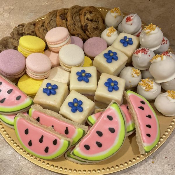 a platter of cookies, macarons, cake pops, and more baked goods